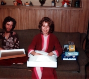 Mom Opening Gift with Buddy Looking On